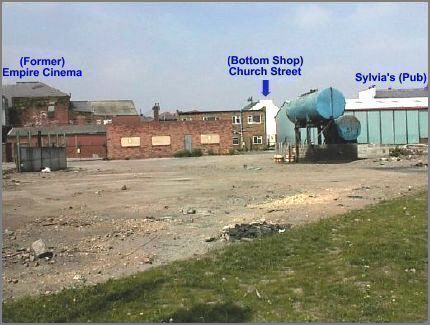 Most of the old buildings in the picture and the blue coloured warehouse are likely to be demolished to make way for new shops, houses and other commercial premises.  Beyond these buildings is the bottom of Church Street.